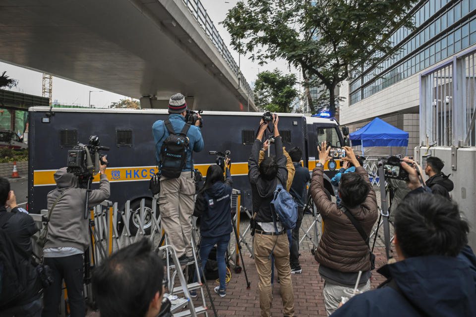 Journalists film a prison van carrying activist publisher Jimmy Lai as it enters the West Kowloon Magistrates' Courts where Lai's trial takes place in Hong Kong, Tuesday, Jan. 2, 2024. (AP Photo/Billy H.C. Kwok)