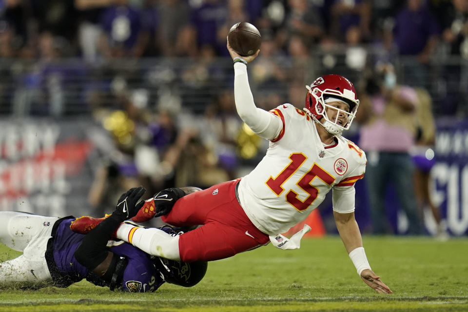 Kansas City Chiefs quarterback Patrick Mahomes makes a pass attempt as he is tackled by Baltimore Ravens linebacker Odafe Oweh in the second half of an NFL football game, Sunday, Sept. 19, 2021, in Baltimore. Ravens cornerback Tavon Young intercepted the pass attempt on the play. (AP Photo/Julio Cortez)