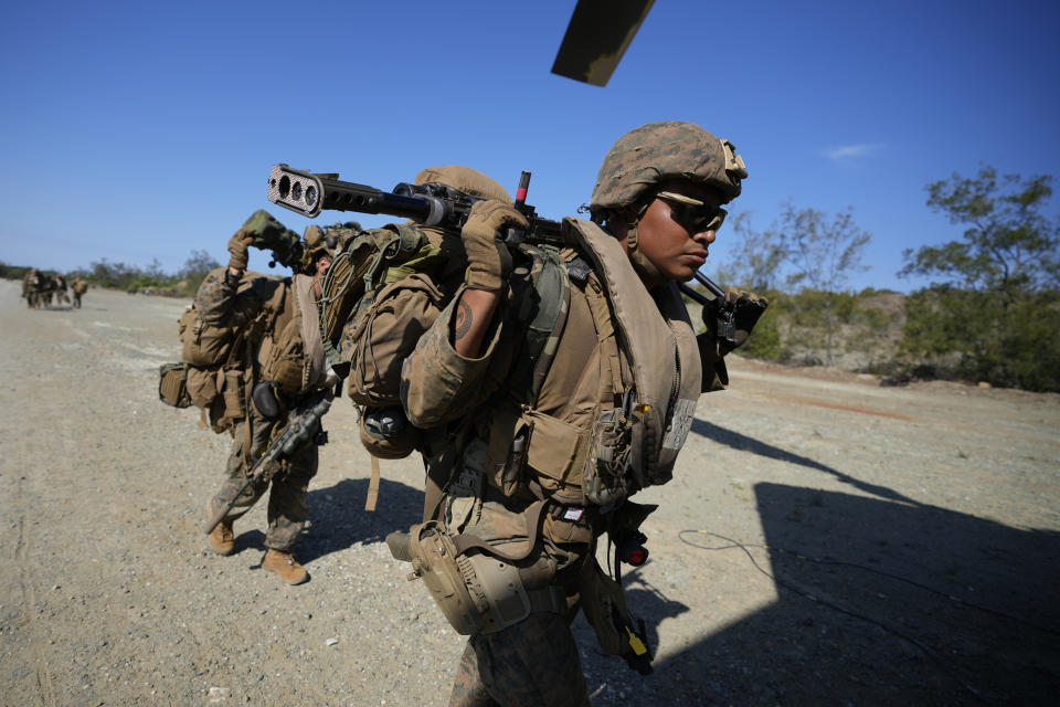 U.S. troopers prepare to board a U.S. Army CH-47s at Paredes Air Station at Pasuquin, Ilocos Norte province as it carries U.S. and Philippine troops during a joint military exercise in northern Philippines on Monday, May 6, 2024. American and Filipino marines held annual combat-readiness exercises called Balikatan, Tagalog for shoulder-to-shoulder, in a show of allied military readiness in the Philippines' northernmost town facing southern Taiwan. (AP Photo/Aaron Favila)