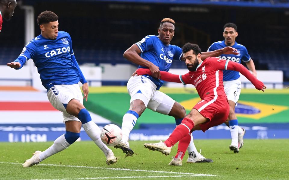 Liverpool's Mohamed Salah (red jersey) in action with Everton's Ben Godfrey and Yerry Mina.