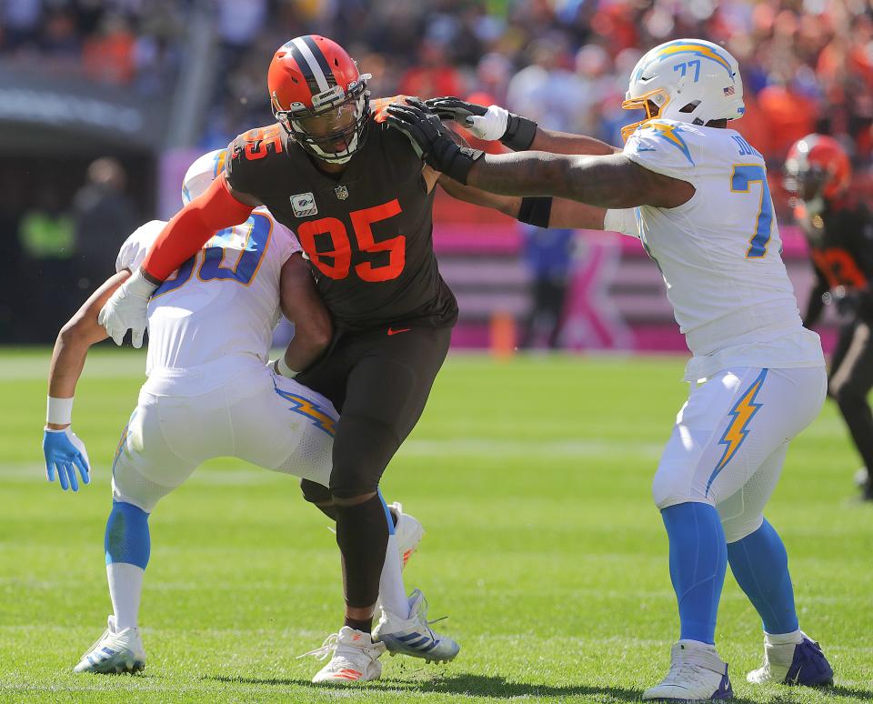 Browns defensive end Myles Garrett fights off a double team by the Los Angeles Chargers on Sunday, Oct. 9, 2022 in Cleveland.