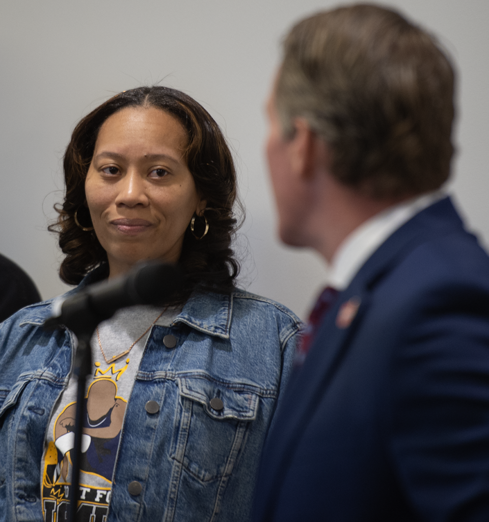 Lt. Governor Jon Husted talks with Tamia Woods, whose 17-year-old son, James, died by suicide in November after he was a victim of sextortion.