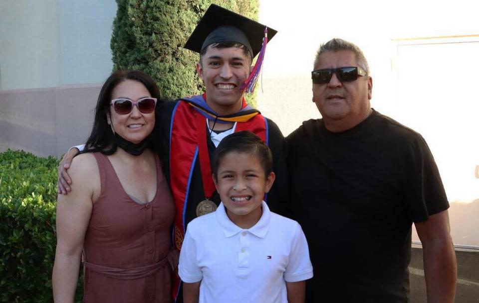 Joey Contreras, the graduate dean't medalist from the Fresno State College of Science and Mathematics, shares a moment with his son, Jayden, stepmother Melinda and father Joe Contreras.