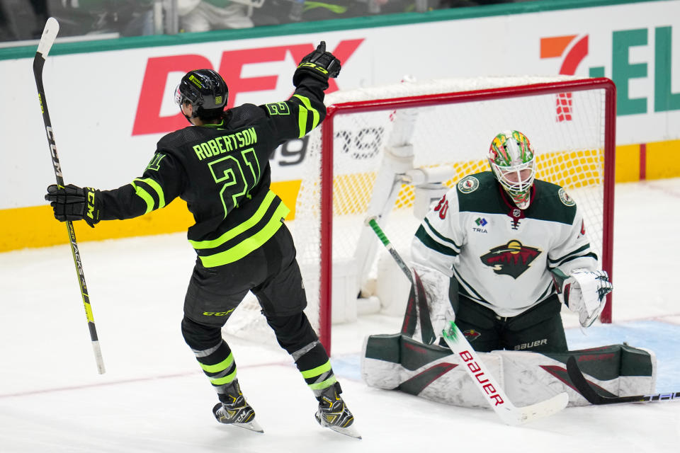 Dallas Stars left wing Jason Robertson (21) reacts after scoring a goal on Minnesota Wild goalkeeper Jesper Wallstedt during the third period of an NHL hockey game, Wednesday, Jan. 10, 2024, in Dallas. The Stars won 7-2. (AP Photo/Julio Cortez)