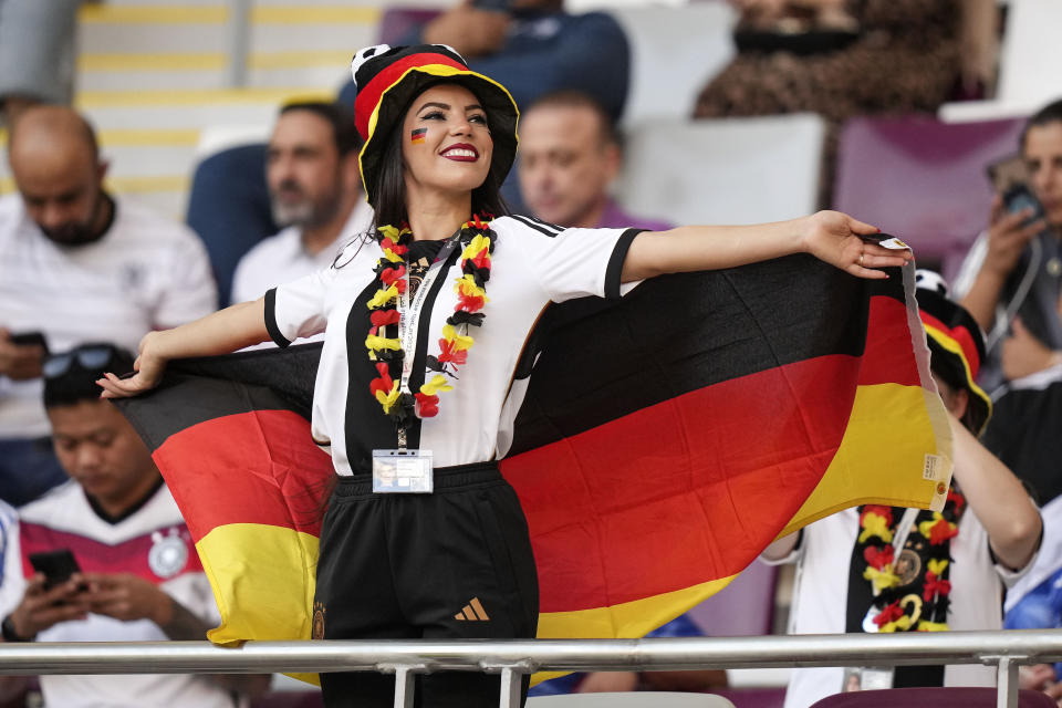 FILE - A woman wearing the German colors cheers on the tribune prior to the World Cup group E soccer match between Germany and Japan, at the Khalifa International Stadium in Doha, Qatar, Wednesday, Nov. 23, 2022. (AP Photo/Matthias Schrader, File)