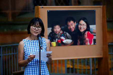 Hua Qu speaks to people as they attend a vigil for Xiyue Wang at Princeton University in Princeton, New Jersey, U.S. September 15, 2017. Picture taken September 15, 2017. REUTERS/Eduardo Munoz