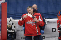 Washington Capitals left wing Alex Ovechkin (8) tapes his stick during a break in the action in the first period of the team's NHL hockey game against the Philadelphia Flyers, Tuesday, April 13, 2021, in Washington. (AP Photo/Nick Wass)