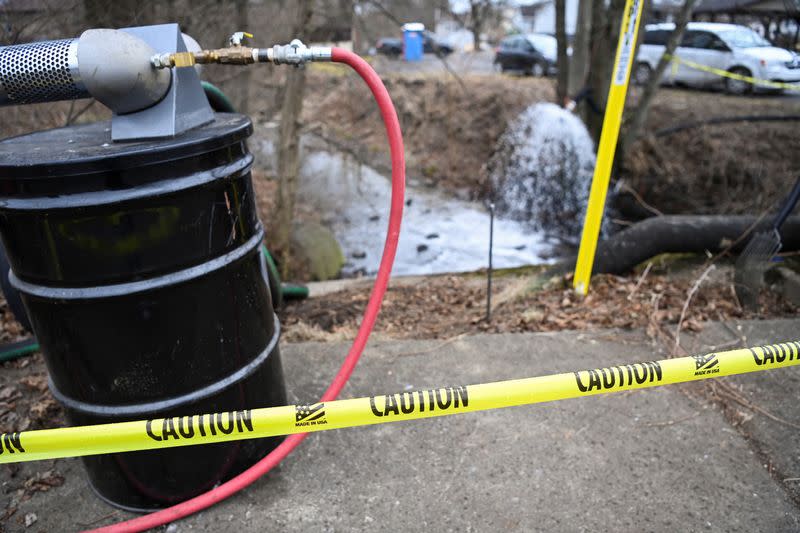 A view of a caution tape as members of the EPA inspect the site of a train derailment of hazardous material in East Palestine