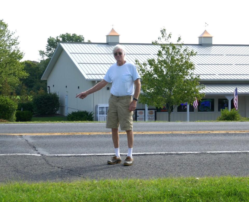 Charles Reichner of Nockamixon points to the raised crack in Route 611 at Ottsville. He and other drivers want the bumps in the roadway fixed as they are affecting their vehicles.