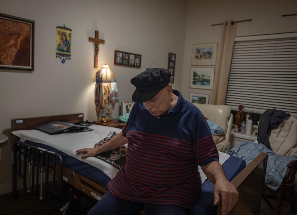 Overcome by grief, Michael Balog weeps on his Mother’s bed on Aug. 31, 2023. Rosalie Davis died earlier in the day at Belmont Village – an assisted living center in Calabasas. Balog decided he would pack up his Mother’s belongings.