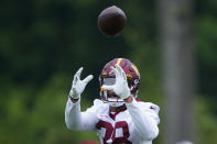 Washington Commanders running back Reggie Bonofon (38) catches the ball during practice at the team's NFL football training facility, Tuesday, May 24, 2022 in Ashburn, Va. (AP Photo/Alex Brandon)