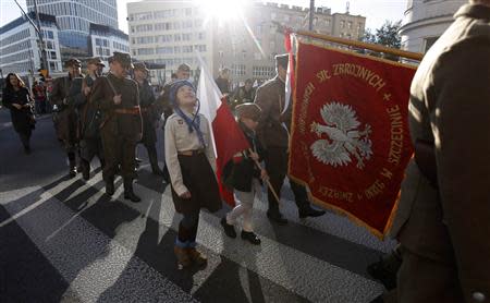 Participants hold flags as they take part in a march, organized by far-right organizations, to honour former Polish, anti-Soviet and anti-Nazi National Armed Forces (NSZ) in Warsaw September 21, 2013. REUTERS/Kacper Pempel