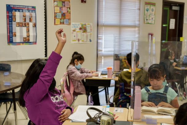 PHOTO: A student raises her hand during a third grade class at Highland Elementary School in Las Cruces, New Mexico, March 4, 2022. (Paul Ratje/AFP via Getty Images)