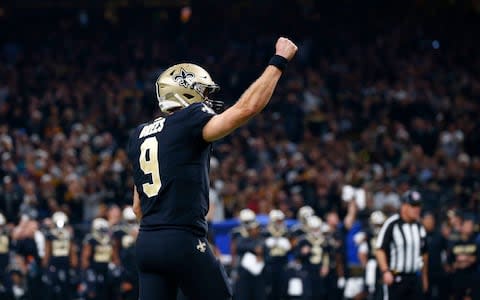 New Orleans Saints quarterback Drew Brees (9) celebrates a touchdown by running back Alvin Kamara, not pictured, in the first half of an NFL football game in New Orleans - Credit: AP