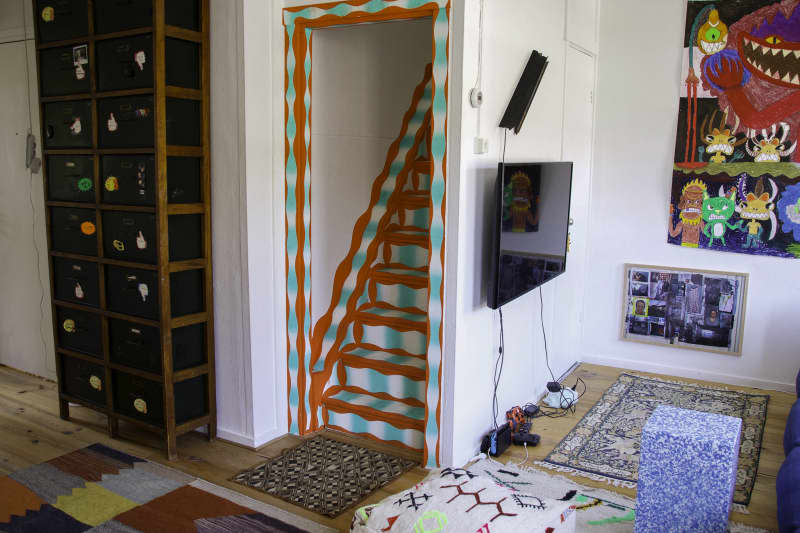 view of patterned red and teal stairs from downstairs room