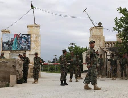 Afghan national Army (ANA) troops keep watch near the site of an ongoing attack on an army headquarters in Mazar-i-Sharif, northern Afghanistan April 21, 2017. REUTERS/Anil Usyan