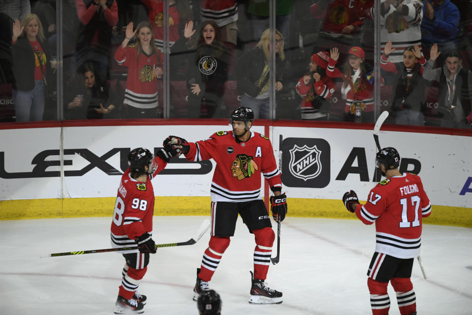 Chicago Blackhawks' Seth Jones (4) celebrates with teammates Nick Foligno (17) and Connor Bedard (98) after scoring a goal during the second period of an NHL hockey game against the Anaheim Ducks Tuesday, March 12, 2024, in Chicago. (AP Photo/Paul Beaty)