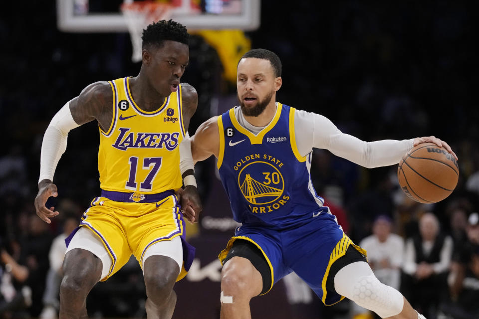 Golden State Warriors guard Stephen Curry, right, is guarded by Los Angeles Lakers guard Dennis Schroder (17) during the first half in Game 6 of an NBA basketball Western Conference semifinal series Friday, May 12, 2023, in Los Angeles. (AP Photo/Ashley Landis)