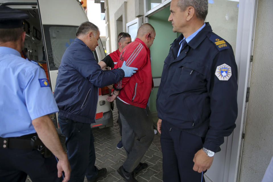 A handcuffed Kosovo Serb man is brought to the hospital in southern Mitrovica, Kosovo, on Tuesday, May 28, 2019. Serbia has put its troops on full alert after heavily armed Kosovo police entered Serb-dominated northern Kosovo, firing tear gas and arresting about two dozen people. It was the latest flare-up in long-simmering tensions between Serbia and its former province, which declared independence from Belgrade in 2008 after a bloody 1998-99 war that ended only with NATO intervention. (AP Photo/Visar Kryeziu)