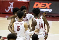 Alabama's Herbert Jones puts his arms around teammates in the final minute of Alabama's NCAA college basketball game against Mississippi State, Saturday, Jan. 23, 2021, in Tuscaloosa, Ala. (AP Photo/Vasha Hunt)