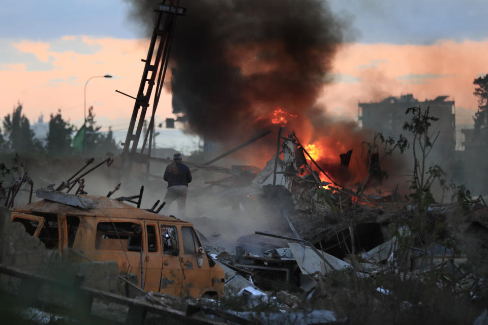 A man checks a destroyed warehouse, destroyed by an Israeli strike, at an industrial district in the southern coastal town of Ghazieh, Lebanon, Monday, Feb. 19, 2024. (AP Photo/Mohammed Zaatari)