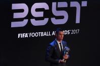 Real Madrid and Portugal forward Cristiano Ronaldo stands with the trophy after winning The Best FIFA men's player of 2017 award on October 23, 2017 in London