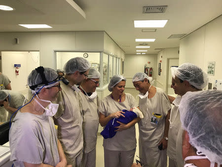 Medical team hold the first baby born via uterus transplant from a deceased donor at the hospital in Sao Paulo, Brazil December 15, 2017 in this picture handout obtained on December 4, 2018. Hospital das Clinicas da FMUSP/via REUTERS