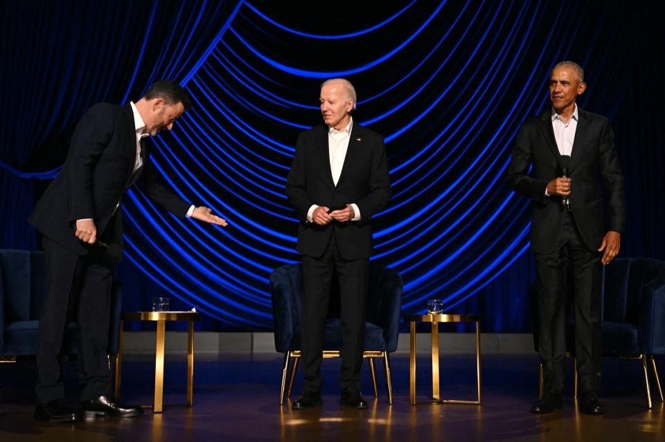 Television host Jimmy Kimmel (L) gestures to offer US President Joe Biden, flanked by former US President Barack Obama (R) onstage during a campaign fundraiser at the Peacock Theater in Los Angeles on June 15, 2024.