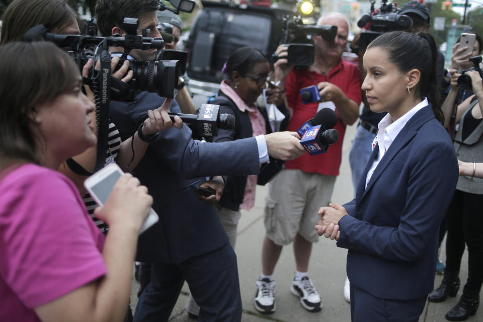 Queens district attorney candidate Tiffany Caban, right, listens to a voter's concern about unvaccinated students not being able to attend school outside her polling place in the Queens borough of New York, Tuesday, June 25, 2019. The race for district attorney of the New York City borough of Queens is shaping up as a battle between moderate Democrats and the left wing of the party. The winner will be strongly favored to win a November general election to succeed the late District Attorney Richard Brown. (AP Photo/Seth Wenig)