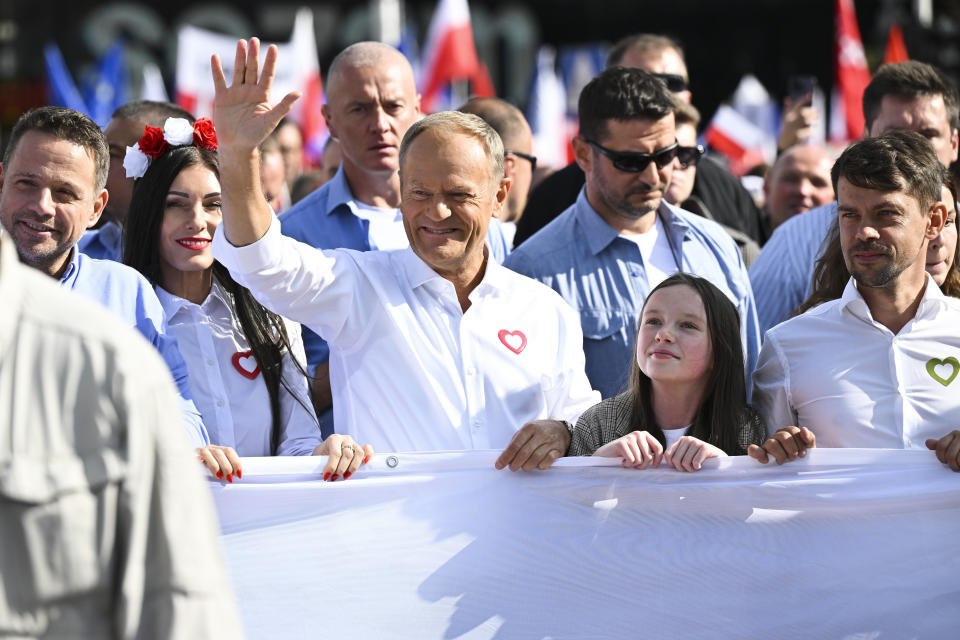 Opposition leader Donald Tusk, center, waves as he leads a march to support the opposition against the governing populist Law and Justice party in Warsaw, Poland, Sunday, Oct. 1, 2023. Polish opposition leader Donald Tusk seeks to boost his election chances for the parliament elections on Oct. 15, 2023, leading the rally in the Polish capital. (AP Photo/Rafal Oleksiewicz)