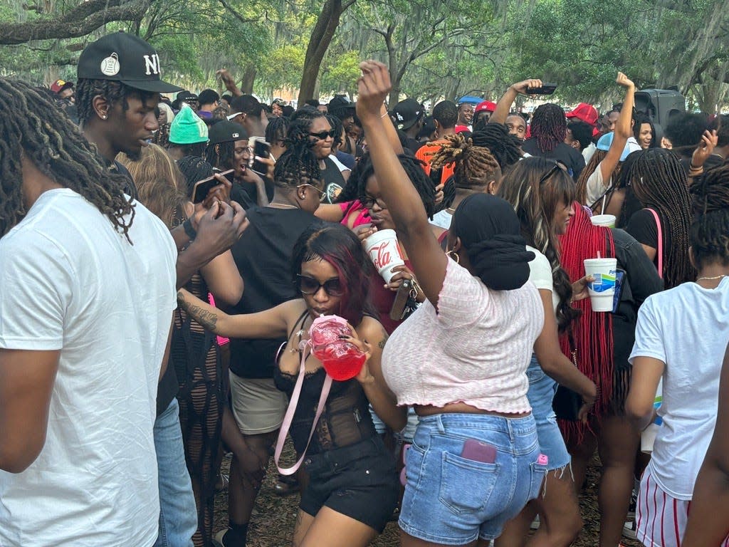 Partyers dance at Daffin Park on Friday, April 19 after a streetwear market was shut down.