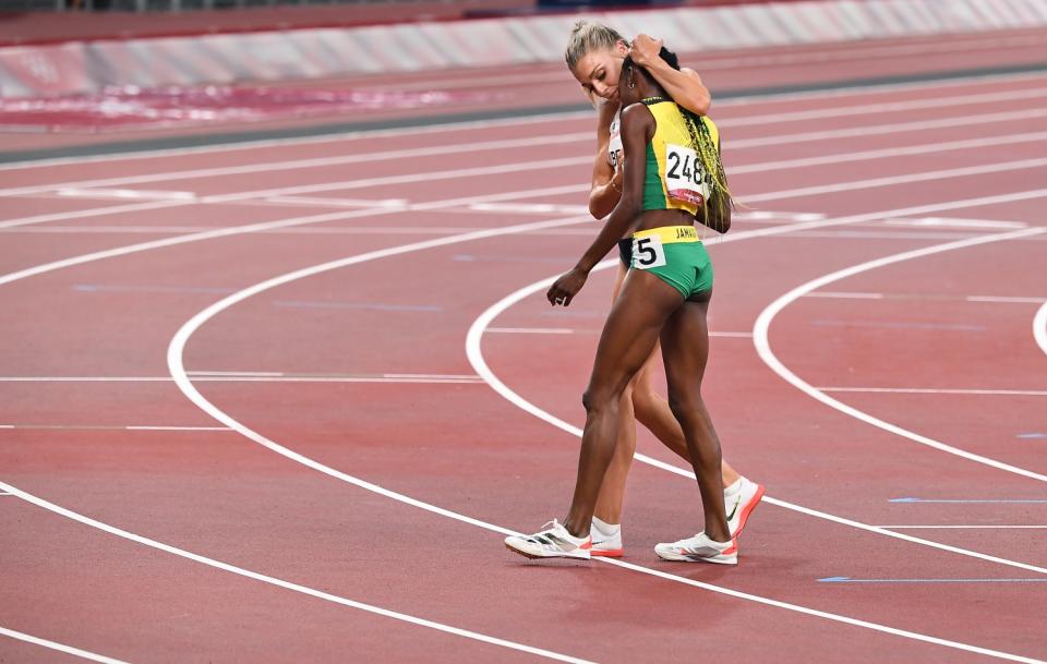 Britain's Alexandra Bell hugs Jamaica's Natoya Goule, foreground, after the 800-meter final.