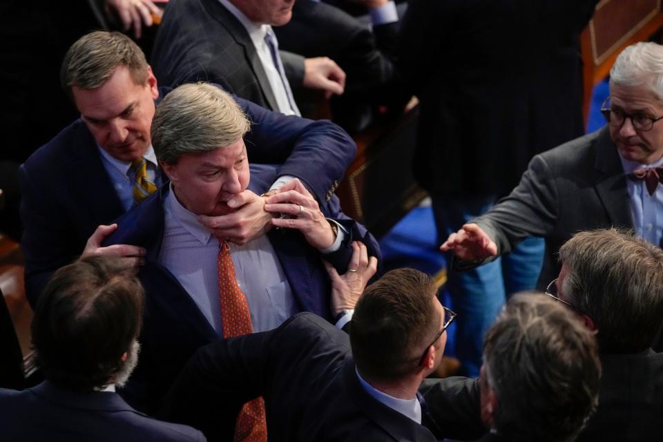 Rep. Richard Hudson, R-N.C., left, pulls Rep. Mike Rogers, R-Ala., back as they talk with Rep. Matt Gaetz, R-Fla., and other during the 14th round of voting for speaker as the House meets for the fourth day to try and elect a speaker and convene the 118th Congress in Washington, Friday, Jan. 6, 2023.