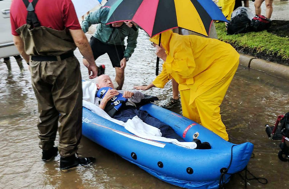 A person is rescued in a Houston neighborhood after water was released to ease overflowing on nearby reservoirs. (Photo: Roque Planas/HuffPost)