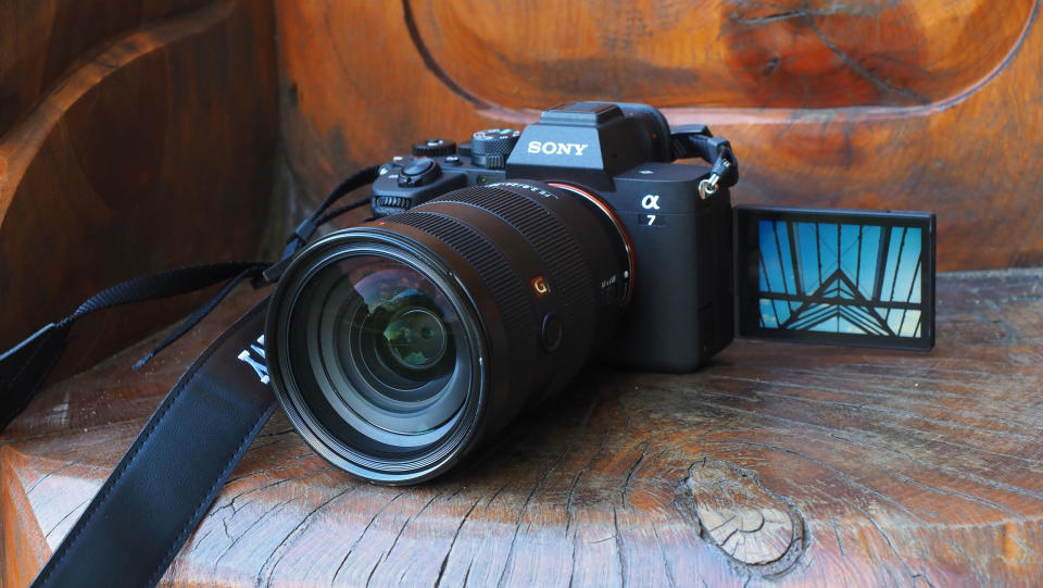 Sony A7 IV with screen flipped out on a wooden background