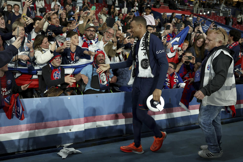 PSG's Kylian Mbappe celebrates PSG's French League One title after the French League One soccer match between Paris Saint-Germain and Toulouse at the Parc des Princes stadium in Paris, Sunday, May 12, 2024. (Franck Fife, Pool via AP)