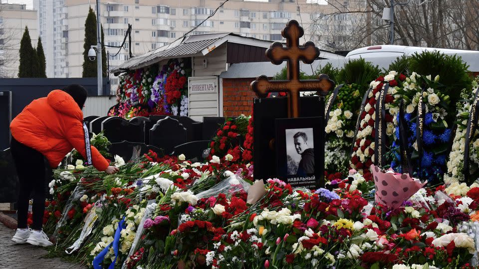 A mourner lays flowers on the grave of Russian opposition leader Alexey Navalny at the Borisovo cemetery in Moscow on March 2, 2024, the day after Navalny's funeral. - Olga Maltseva/AFP/Getty Images