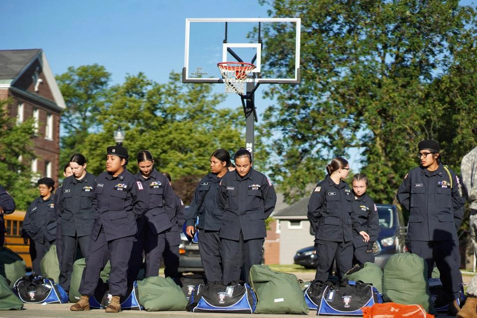 Cadet Estrella Mirroquin, center under hoop, and first platoon wait for directions outside of the Michigan Youth Challenge Academy in Battle Creek on Saturday, June 15, 2024.