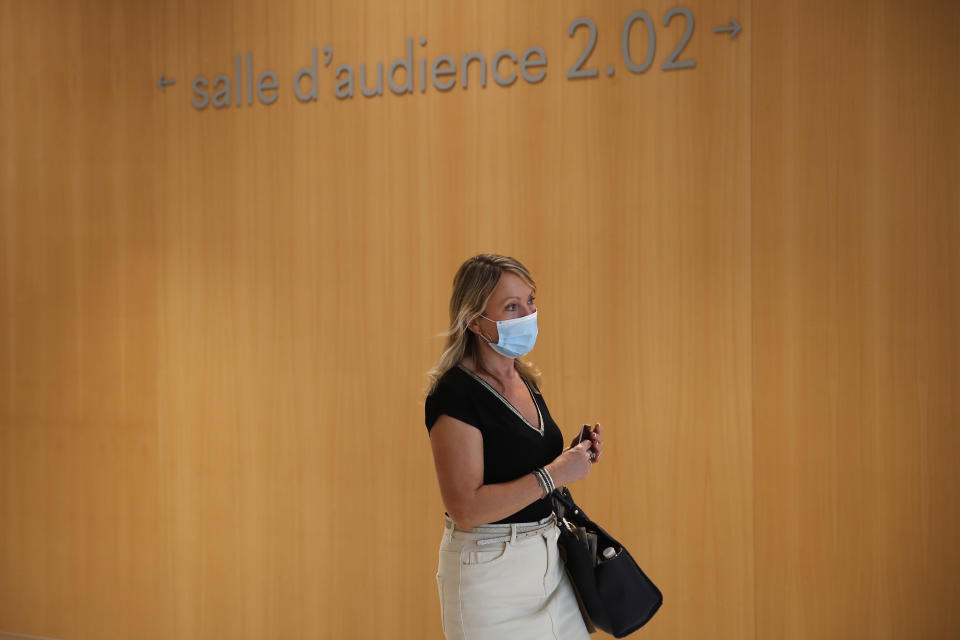 Gala Renaud, widow of Michel Renaud who was killed in Charlie Hebdo office, arrives at the courtroom on the opening day of the 2015 attacks trial, Wednesday, Sept. 2, 2020 in Paris. Thirteen men and a woman go on trial Wednesday over the 2015 attacks against a satirical newspaper and a kosher supermarket in Paris that marked the beginning of a wave of violence by the Islamic State group in Europe. Seventeen people and all three gunmen died during the three days of attacks in January 2015. (AP Photo/Francois Mori)