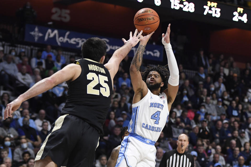 North Carolina's R.J. Davis (4) shoots over Purdue's Ethan Morton (25) in the first half of an NCAA college basketball game, Saturday, Nov. 20, 2021, in Uncasville, Conn. (AP Photo/Jessica Hill)