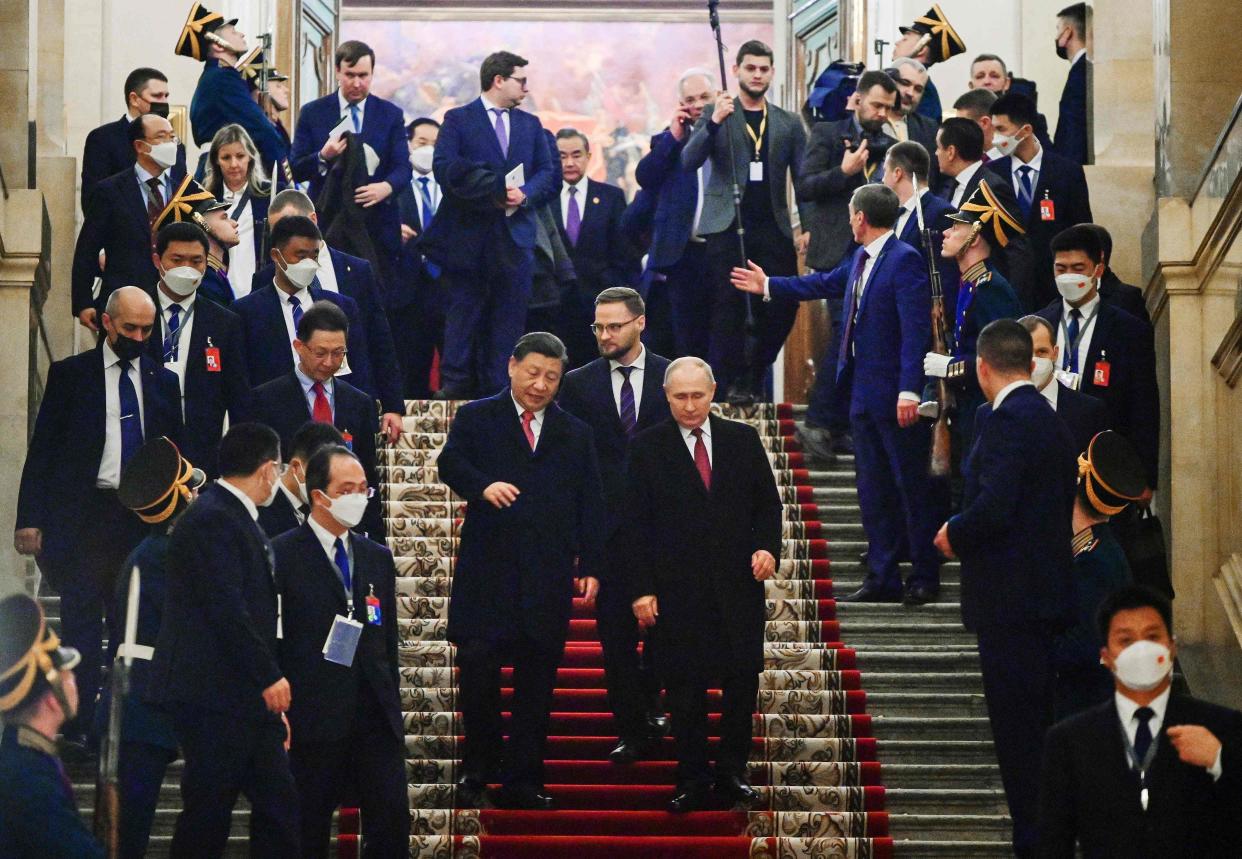 Russian President Vladimir Putin and China’s President Xi Jinping leave after a reception (SPUTNIK/AFP/Getty)