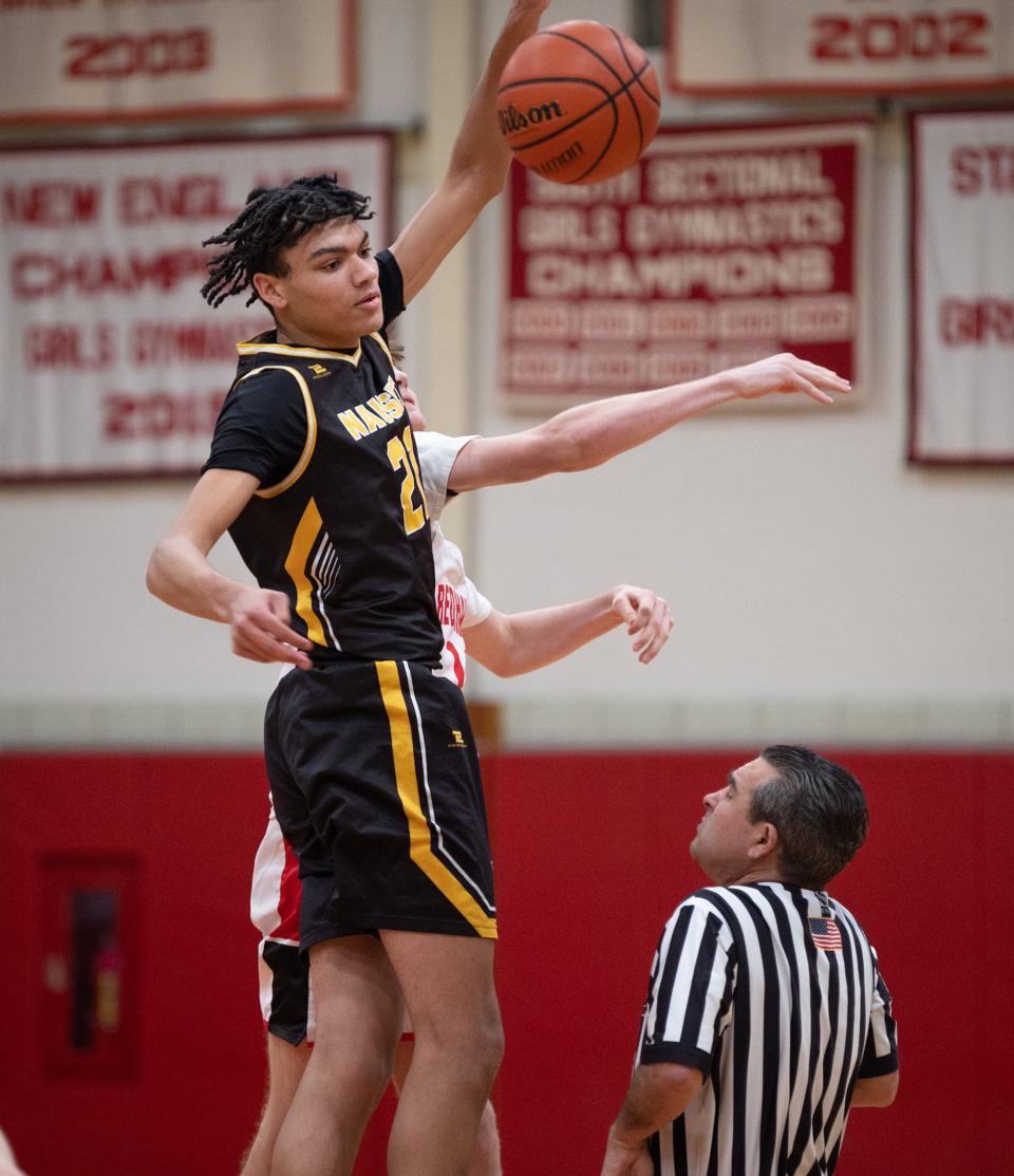 Nauset's Nico Harrington, #21, wins the tip-off starting the Barnstable Redhawks vs. Nauset Warriors game at Barnstable High School on Tuesday night. Rebecca Corliss/Cape Cod Times
(Photo: REBECCA CORLISS / CAPE COD TIMES)