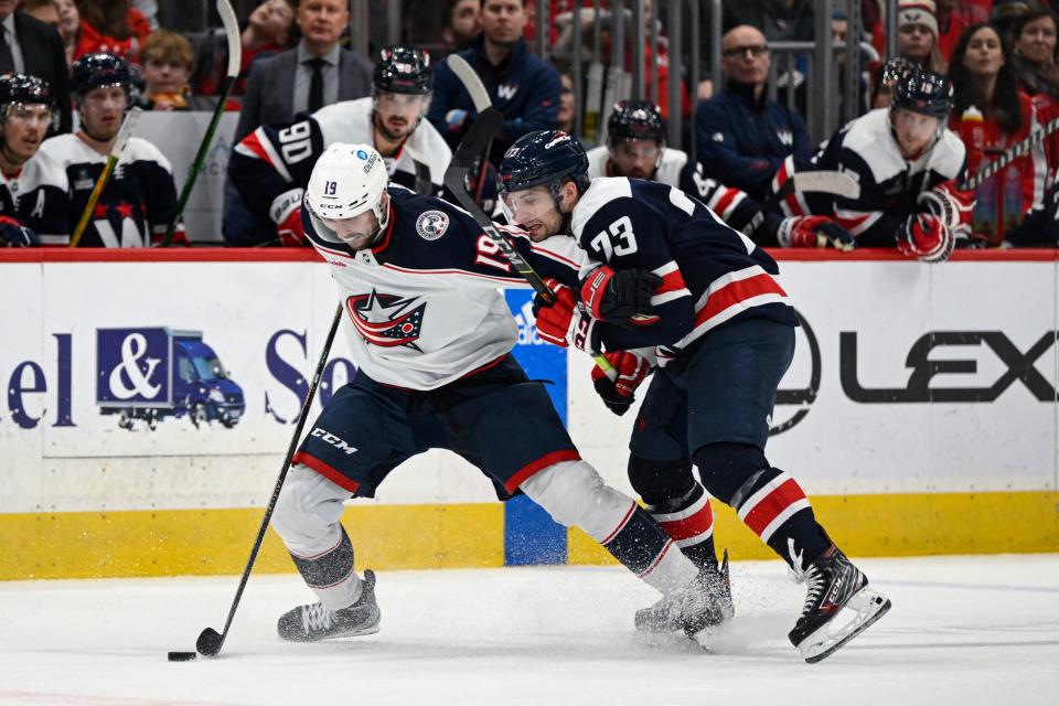 Columbus Blue Jackets center Liam Foudy (19) competes for the puck against Washington Capitals left wing Conor Sheary during the second period of an NHL hockey game, Sunday, Jan. 8, 2023, in Washington. (AP Photo/Terrance Williams)