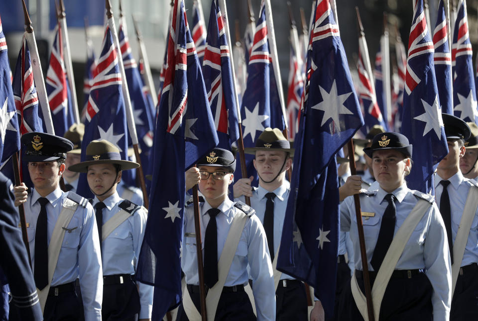 Flag bearers carry Australian flags during a march celebrating ANZAC Day, a national day of remembrance in Australia and New Zealand that commemorates those that served and died in all wars, conflicts, and while peacekeeping, in Sydney, Australia, Thursday, April 25, 2019. (AP Photo/Rick Rycroft)