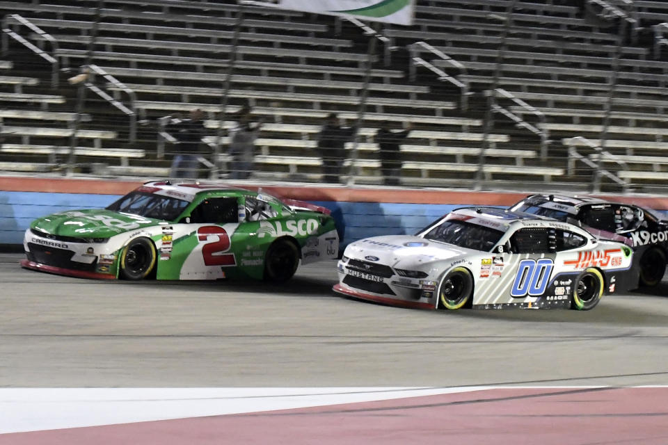 Tyler Reddick (2) and Cole Custer (00) head into the front stretch during the NASCAR Xfinity Series auto race at Texas Motor Speedway in Fort Worth, Texas, Saturday, Nov. 2, 2019. (AP Photo/Randy Holt)