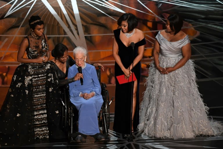 NASA physicist Katherine Johnson (C) is surrounded by singer and actress Janelle Monae (L), actress Taraji P. Henson (2ndR) and actress Octavia Spencer (R) as they present on stage the Best Documentary Feature award at the 89th Oscars