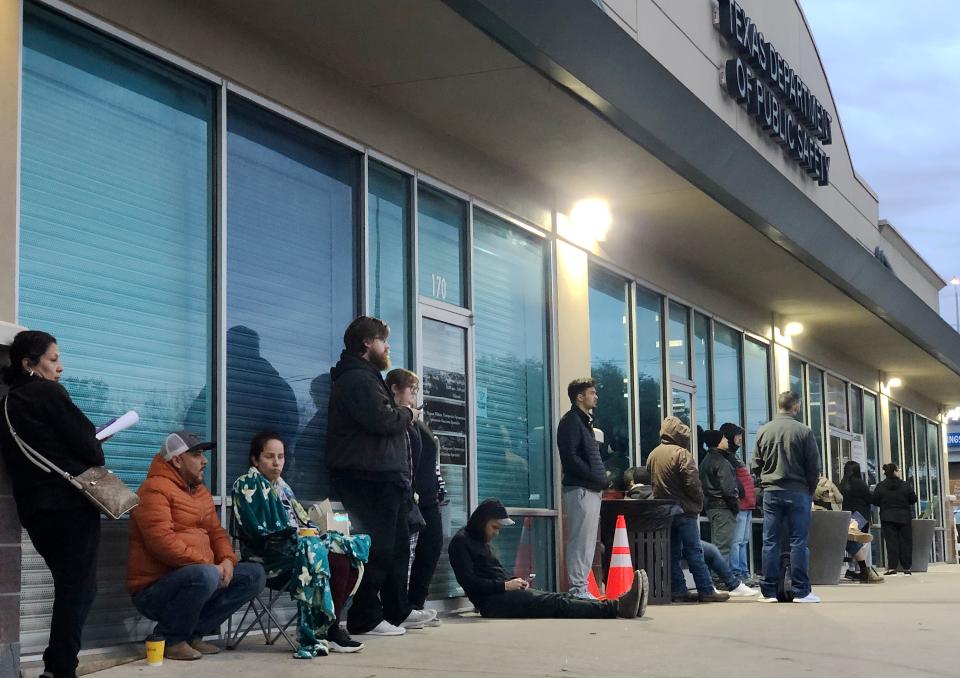 Dozens of people wait in line before dawn for the opening of the South Austin driver's license office run by the Texas Department of Public Safety. About 50 people were waiting by the time the office opened at 8 a.m. Friday.