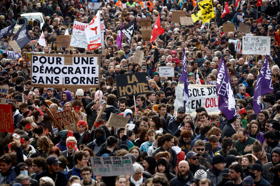 Protesters attend a demonstration during the ninth day of nationwide strikes and protests against French government's pension reform, in Nantes, France, March 23, 2023. The slogan reads 