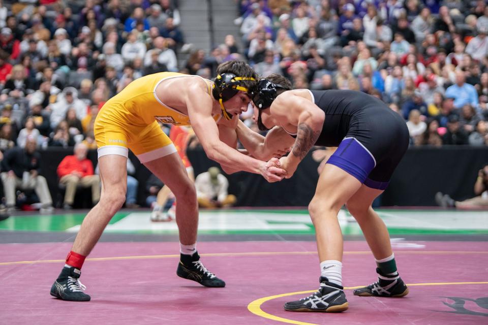 Pueblo East's Niko Fernandez, left, clinches with Damien Reyes of Mesa Ridge during their Class 4A 132-pound semifinal matchup on day two of the CHSAA state wrestling tournament on Friday, February 16, 2024.