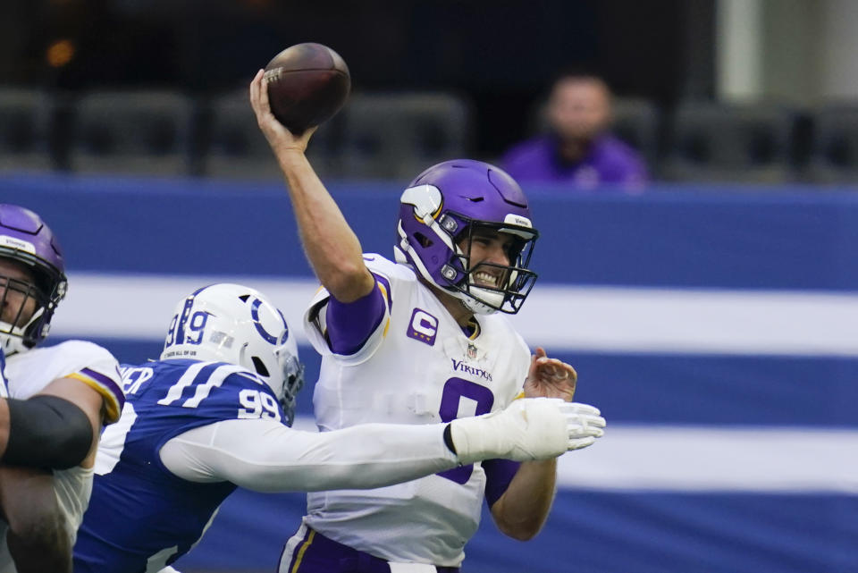 Minnesota Vikings quarterback Kirk Cousins (8) throws while pressured by Indianapolis Colts' DeForest Buckner (99) during the second half of an NFL football game, Sunday, Sept. 20, 2020, in Indianapolis. (AP Photo/Michael Conroy)